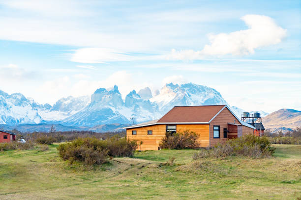 The mountain view of Torres del Paine from cottages (Hosteria Lago Tyndall) in the Parque Nacional Torres del Paine at dusk. Magallanes y la Antártica Chilena Region, Chile.