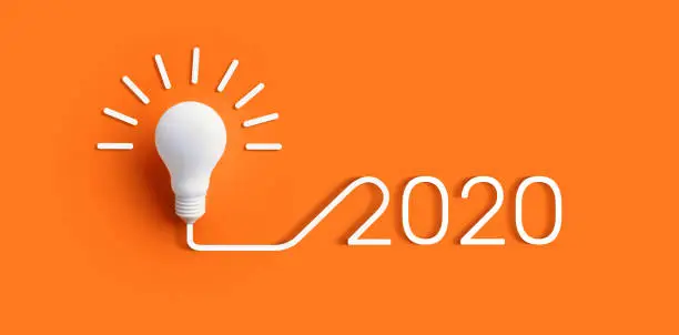 Photo of 2020 creativity inspiration concepts with lightbulb on color background.Business solution