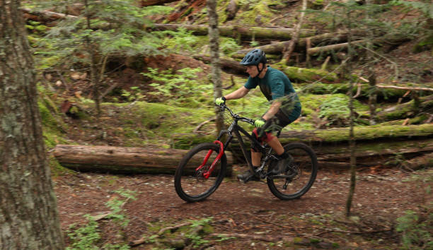 istock Male mountain biker follows trail through forest 1167057515