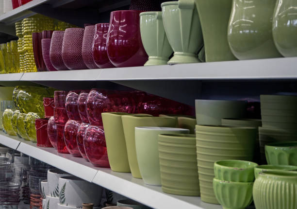 gardening, sale and consumerism concept - flower pots on shelves at garden shop