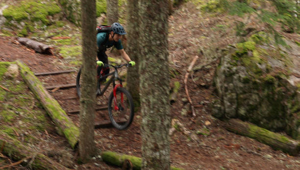 istock Male mountain biker follows trail through forest 1167057586
