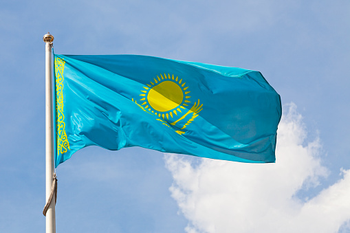 Flag of Kazakhstan waving atop of its pole.