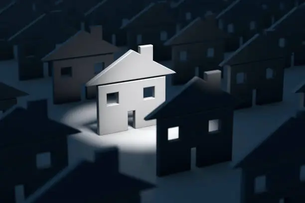 Real estate concept image of standing out of the crowd with one home being illuminated and standing out.