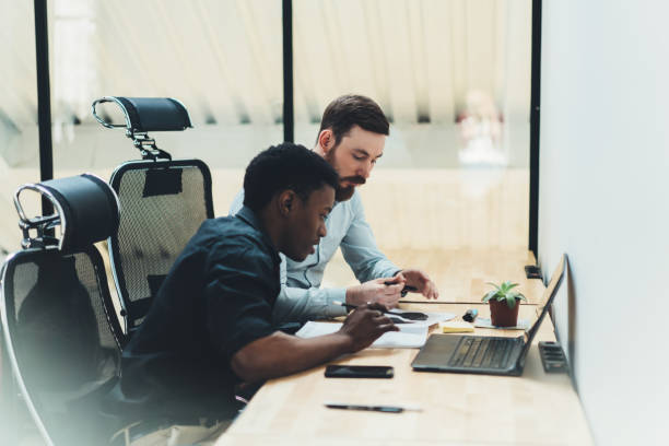 istock African american student with qualified tutor discussing studying project during private lesson sitting at laptop computer with wireless internet.Two colleagues teamworking on solution in office 1167057946