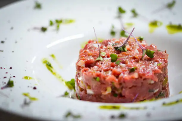 fresh beef tartar dish with tasty vegetables