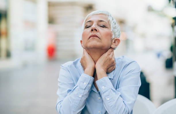 Feeling Down Stressed mature woman massaging her neck. older woman eyes closed stock pictures, royalty-free photos & images