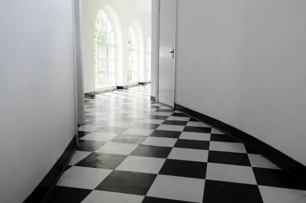White art-deco hall with black and white floor tiles