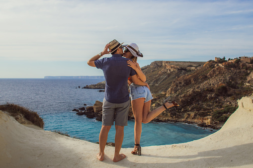 Couple embrace in the day on the seaside, beautiful view to sea