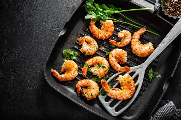 istock Grilled shrimps on pan on dark background 1167064280