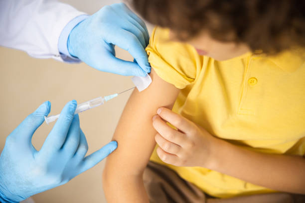 istock Child given shot by practitioner stock photo 1167064356