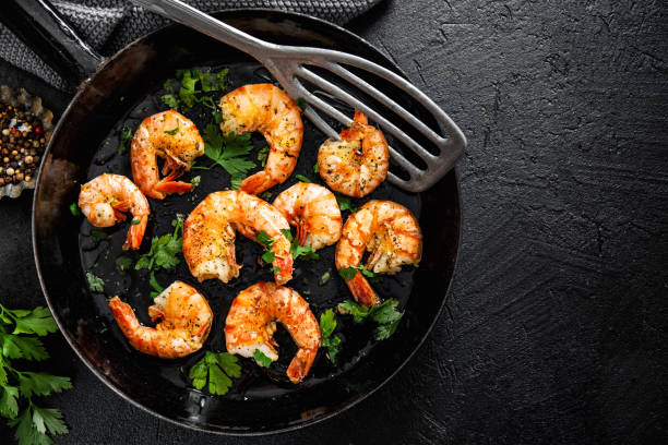 istock Grilled shrimps on pan on dark background 1167064803