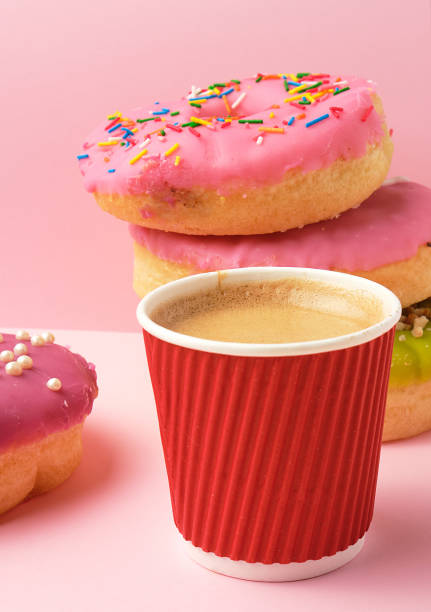 istock round red glazed donut and paper cup with coffee 1167068473