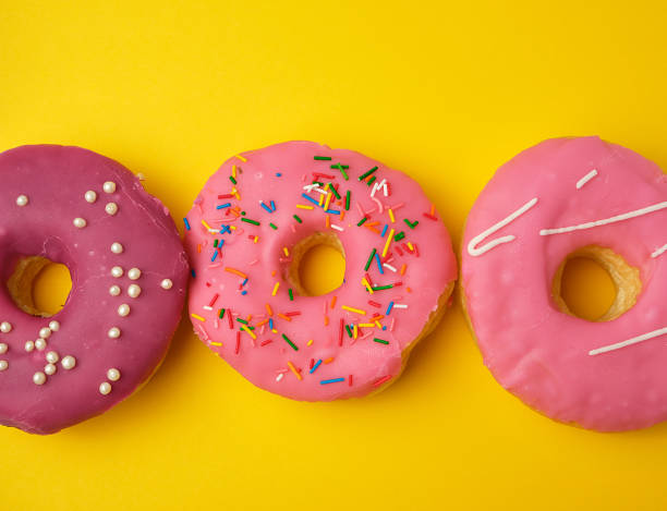 istock round different sweet donuts with sprinkles on a yellow background 1167071241
