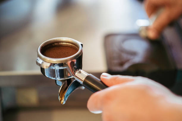 istock Barista making an espresso coffee with a tamper 1167074061
