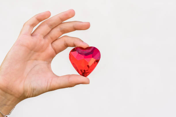 istock woman hand holds red heart. 1167077034