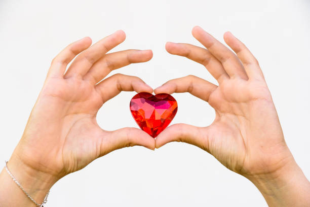 istock woman hand holds red heart. 1167077048