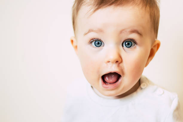 Baby with flu looking surprised Baby with flu looking surprised blue eyes photos stock pictures, royalty-free photos & images
