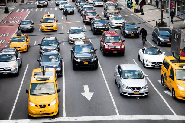 Traffic at Streets Intersection in Midtown Manhattan, New York City Traffic on 2nd Ave in Midtown Manhattan, New York City. car city urban scene commuter stock pictures, royalty-free photos & images