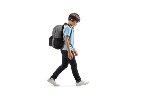 istock Sad schoolboy walking with his hand down 1167082180