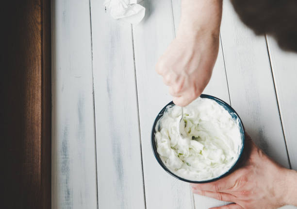 Top view of a man picking green cucumber. The concept of preparing a salad, salad and dinner.