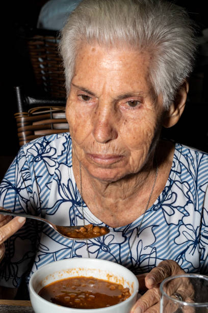 istock 90 year old lady eating soup 1167088638