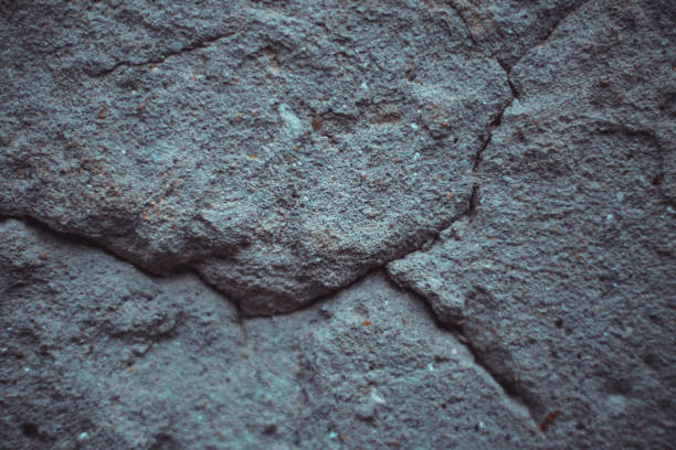 istock Top view shot of cracked grey asphalt 1167092664