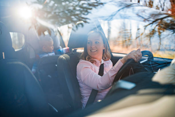 istock Mother and young son driving in a car on a sunny day 1167097018