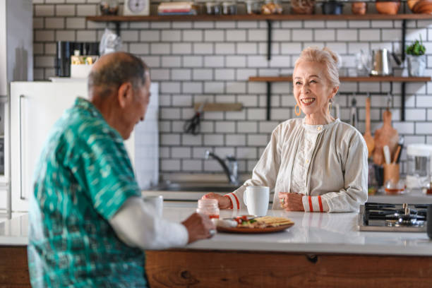 istock Senior Japanese Couple Enjoying Breakfast at Kitchen Counter 1167097033