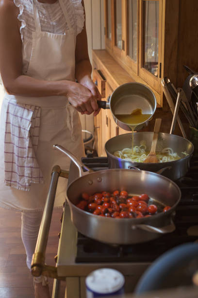 istock Pan with caramelised tomatoes cherry process of cooking and adding ingredients hands 1167097110