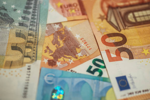 European Union Euro Currency banknotes with Europe map European Union Euro Currency banknotes with Europe map five euro banknote photos stock pictures, royalty-free photos & images