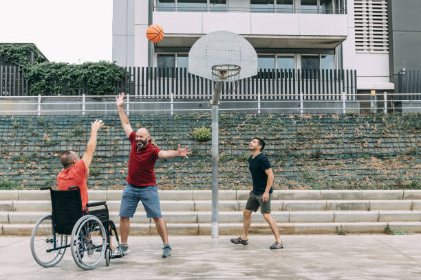 istock disabled man playing basketball with two friends 1167097263
