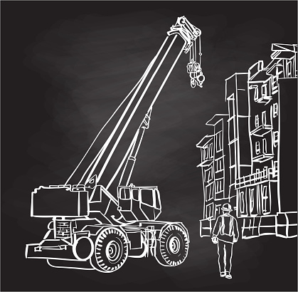 Crane on construction site with condo apartments and worker on the ground