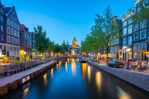istock Saint Nicholas Church with Amsterdam skyline at night in Netherlands 1167101332