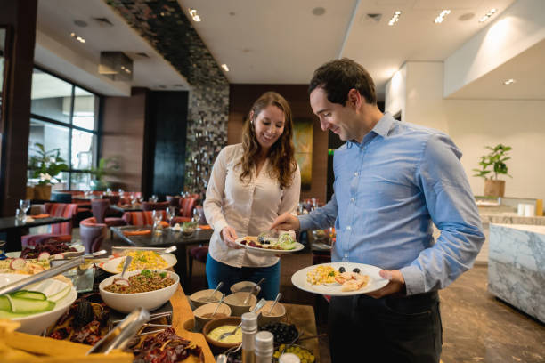 istock Loving man serving partner at the hotel buffet both having a nice time 1167105385