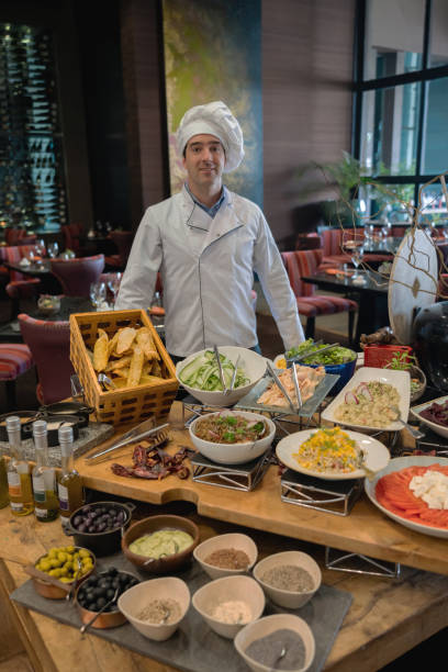 istock Friendly chef at a luxury hotel salad bar smiling at camera 1167105398
