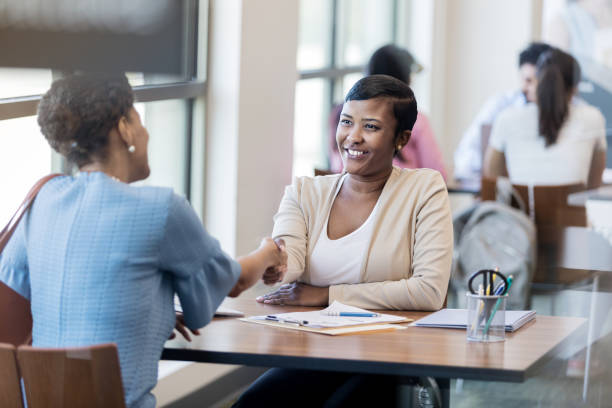 istock Banker and customer shake hands before discussing business 1167108551