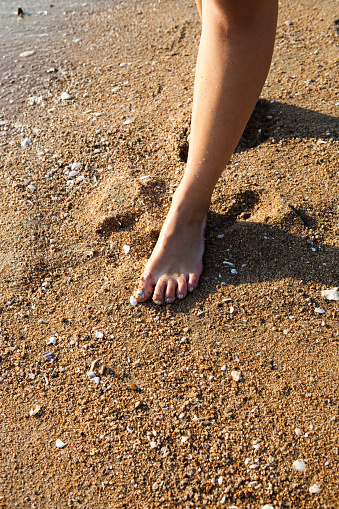 Summer vacation concept. Flip flops on a sandy ocean beach.
