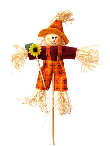 Girl Scarecrow, pumpkins, sunflowers on bales of hay for a hayride on the bed of an old rustic antique truck in Tennessee, USA.  Autumn decoration. Halloween. Harvest Festival. Thanksgiving.