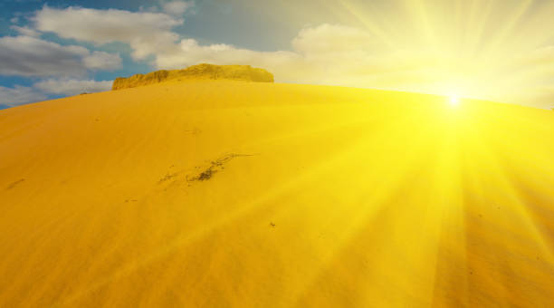 istock sandy desert dune under a cloudy sky in a sparkle sunlight 1167123541