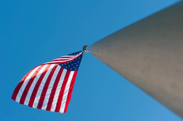 istock American Flag as seen from below against bright blue sky 1167129249