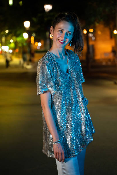 istock Well dressed woman in a glowing suit, walking at night 1167129815