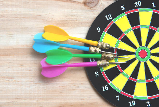 istock Darts and dart board on the wooden table 1167132800