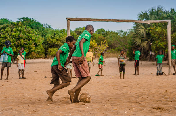 local teens in a small community playing football, in kids day in Mozambique