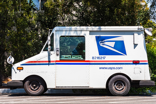 August 8, 2019 Palo Alto / CA / USA - USPS vehicle parked on the side of the road
