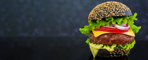 istock Delicious handmade burger on dark background. Banner. 1167136844
