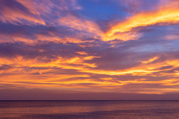 istock Colorful sunset sky over the ocean with dramatic cloud formation 1167138908