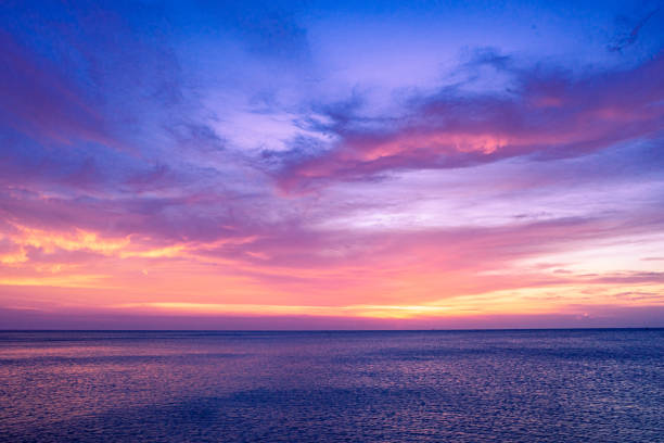 istock Colorful sunset sky over the ocean with dramatic cloud formation 1167138926