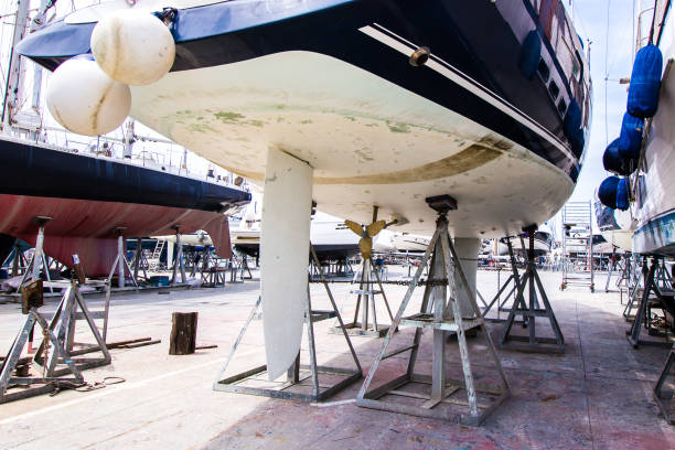 boat with blue hull in maintenance boat with blue hull in maintenance at the shipyard motorboat maintenance stock pictures, royalty-free photos & images