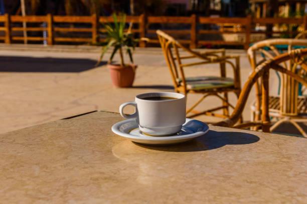 Cup of coffee on table in street cafe
