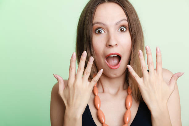 istock Surprised shocked woman face with open mouth 1167145050